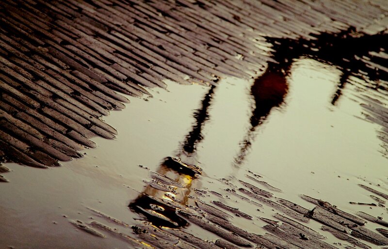 Reflection of Person in Puddle