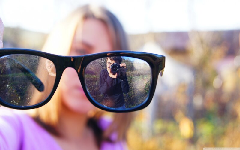 Reflection of Photographer in Glasses