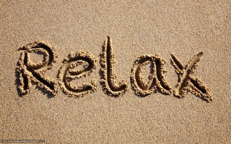 Relax written in sand
