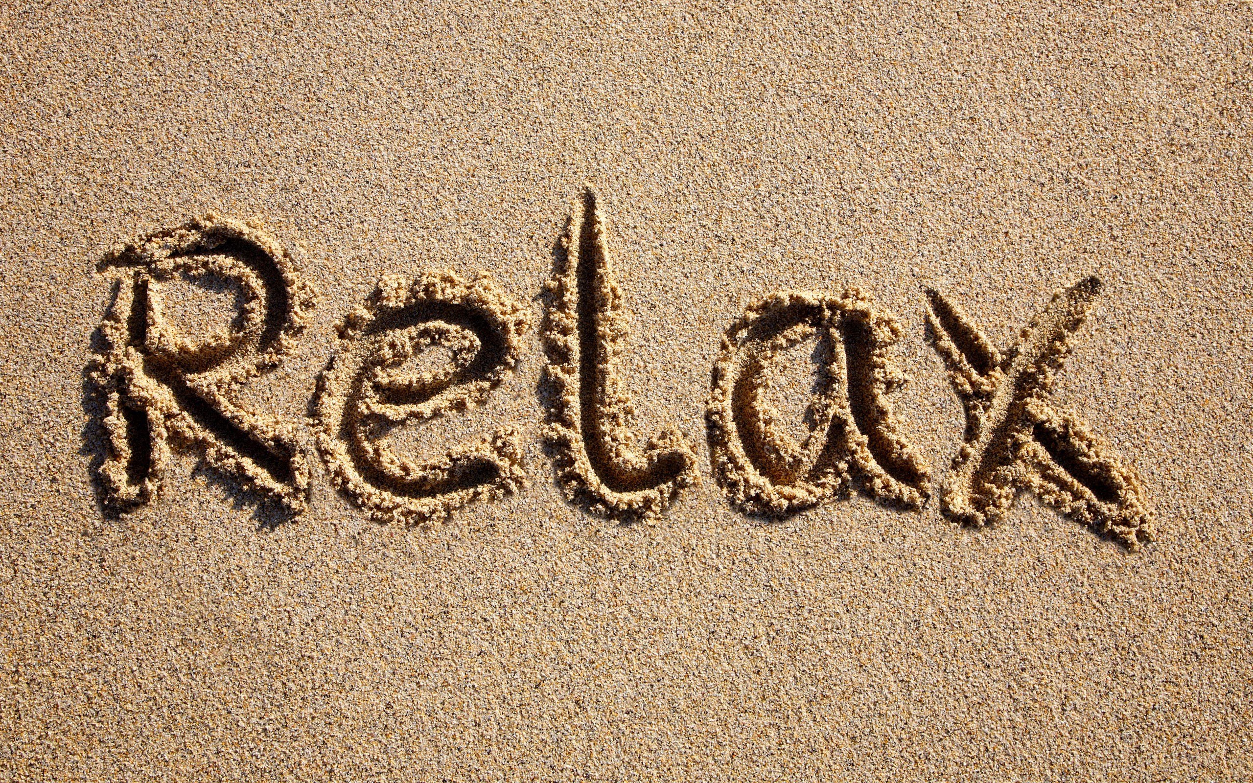 relax written in sand