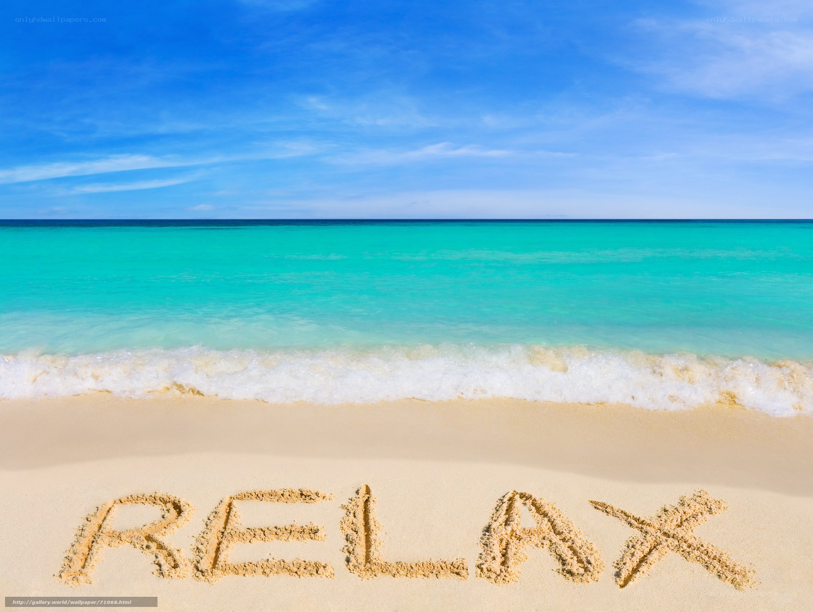 Relax written in sand on a tropical beach