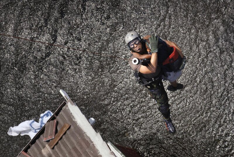 Rescue worker rescues person from roof