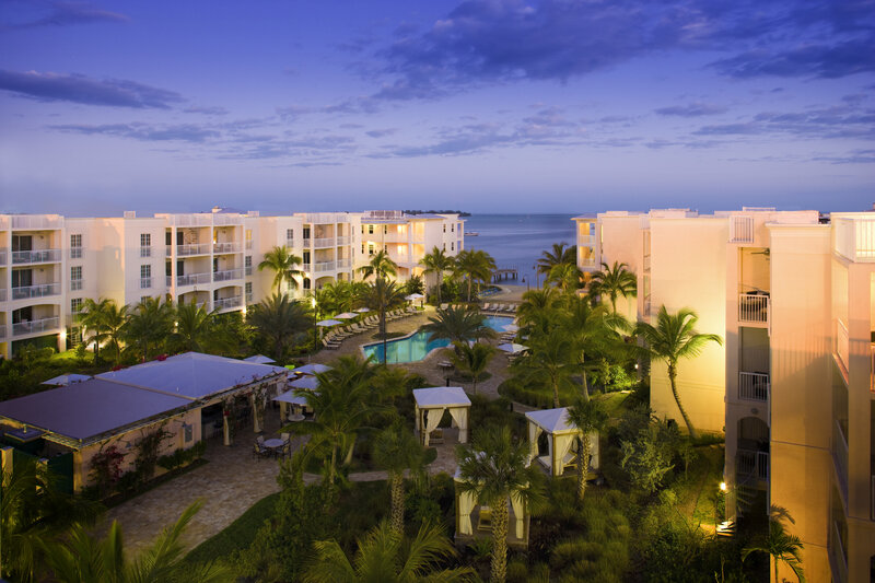 Resort at dusk with pool and ocean view