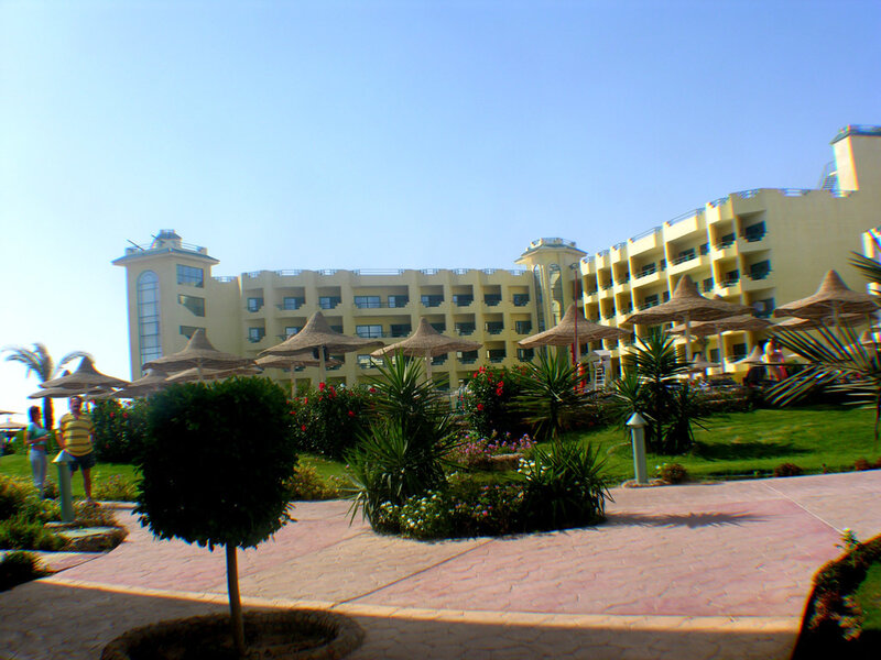 resort with umbrellas and building