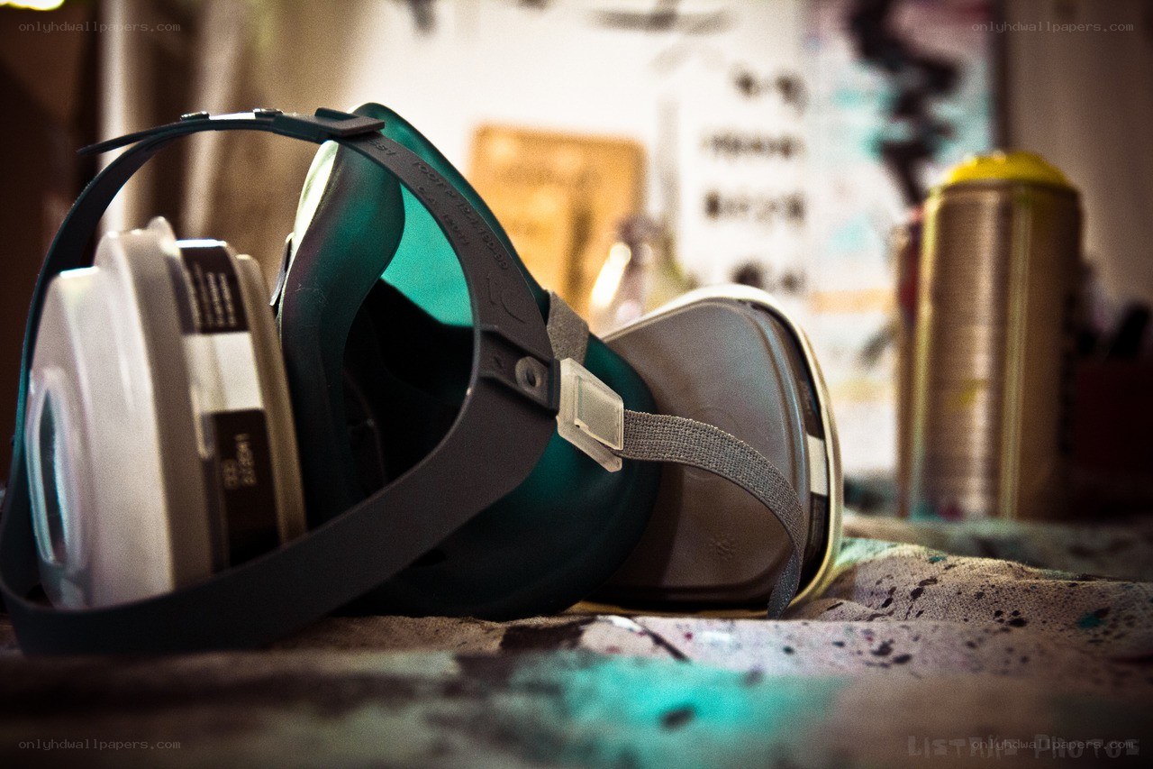 respirator mask on paint-splattered surface