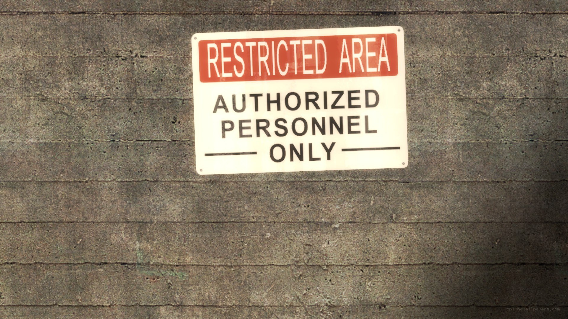 Restricted area sign on concrete wall
