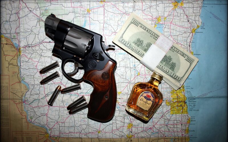 Revolver, money, and liquor on map