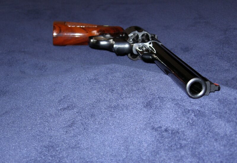 Revolver on Blue Surface — Neutral