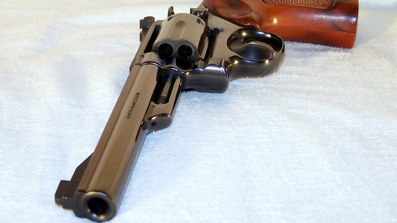 Revolver on White Surface — Black, Neutral
