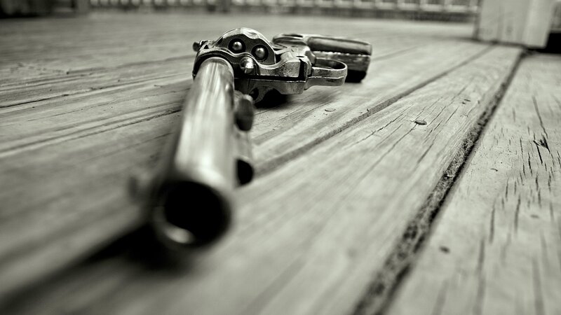 Revolver on Wooden Surface — Black, Dramatic