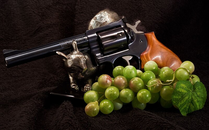 Revolver with grapes and figurine