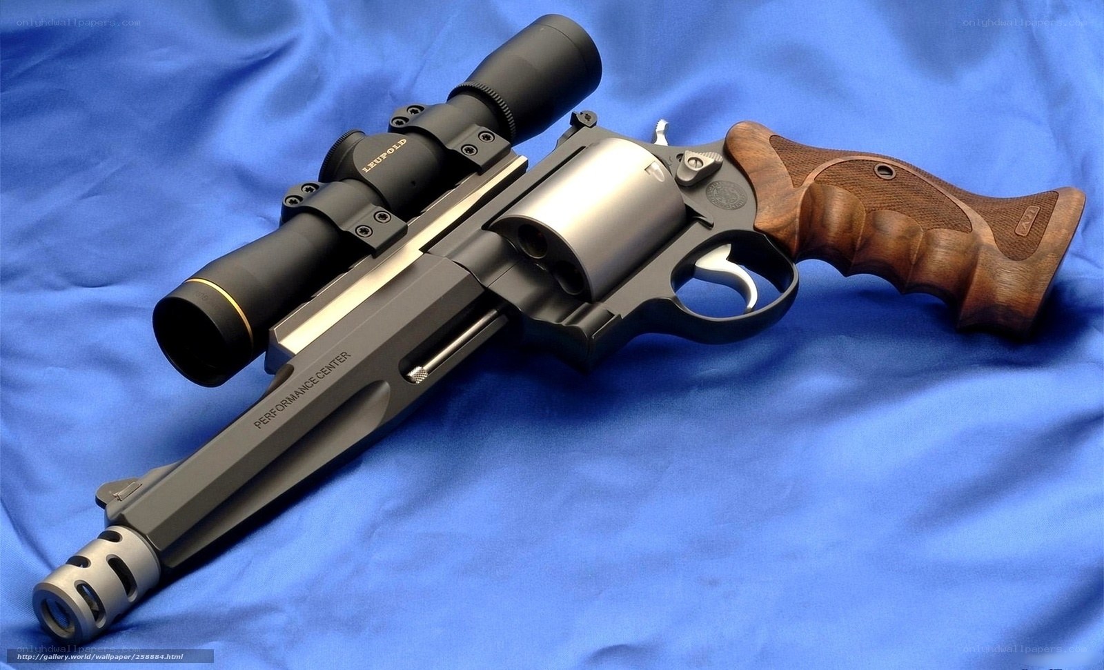 revolver with scope on blue cloth