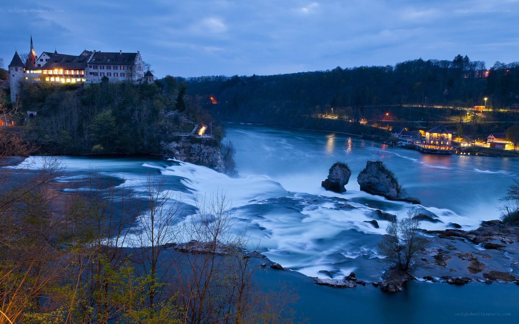 Rhine Falls at dusk with castle