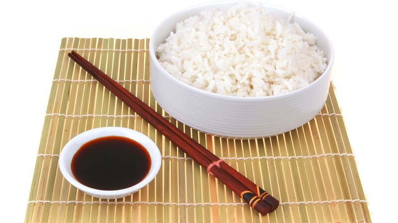 Rice with soy sauce and chopsticks