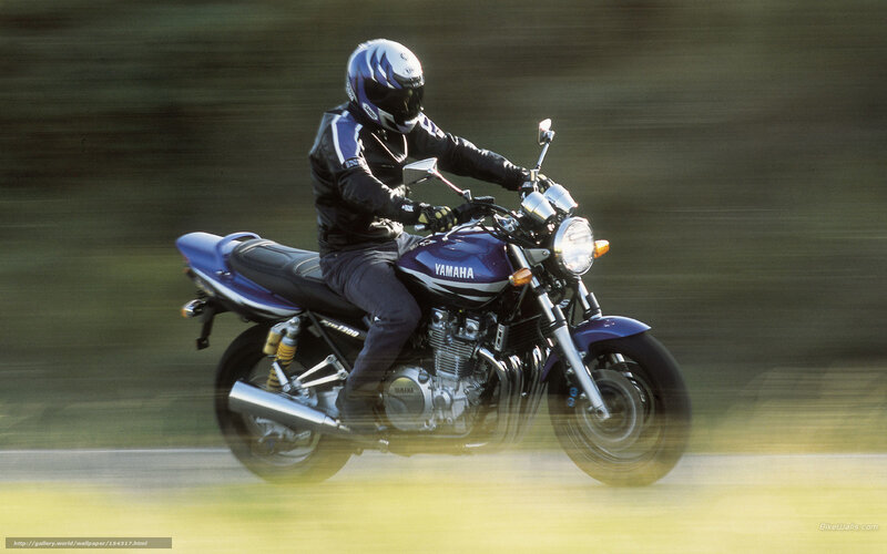 Rider on a blue Yamaha motorcycle