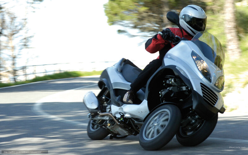 rider on a three-wheeled scooter