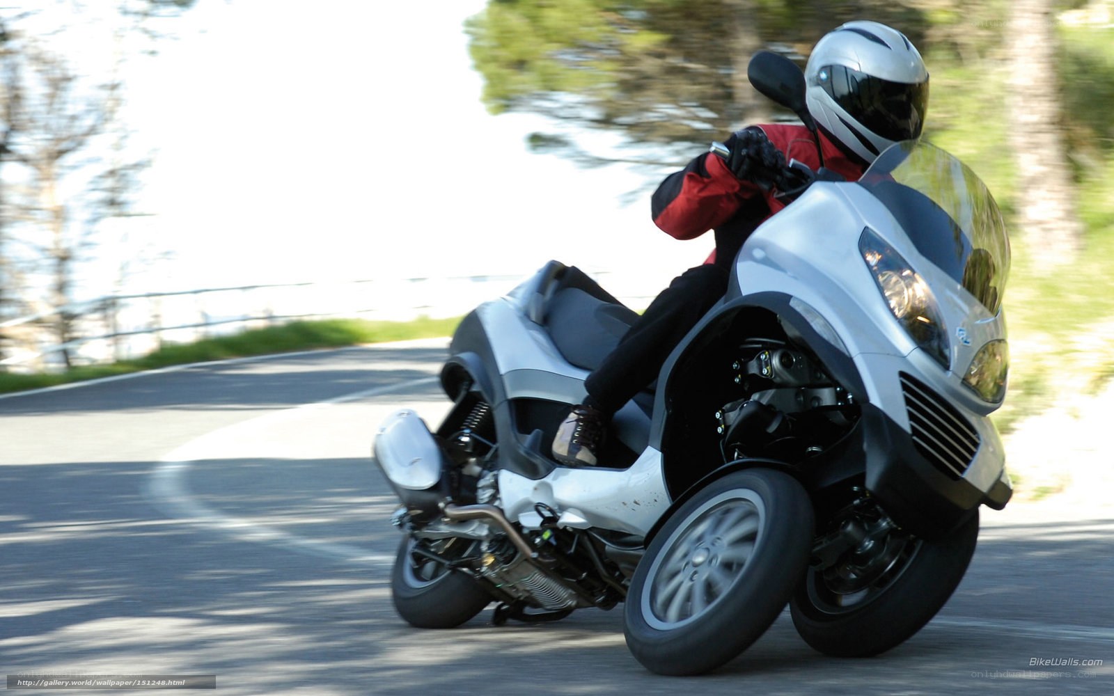 rider on a three-wheeled scooter