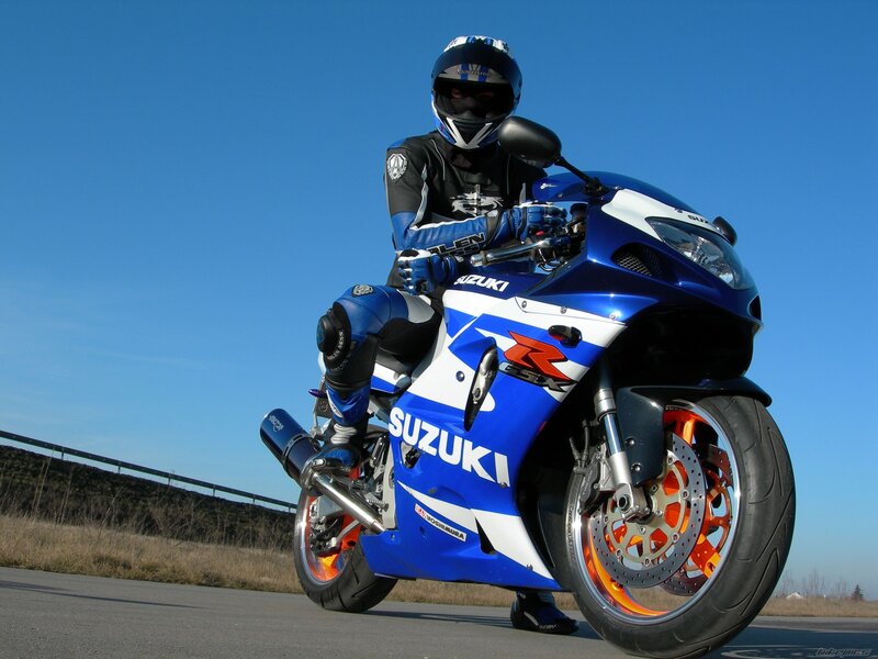 rider on blue Suzuki motorcycle