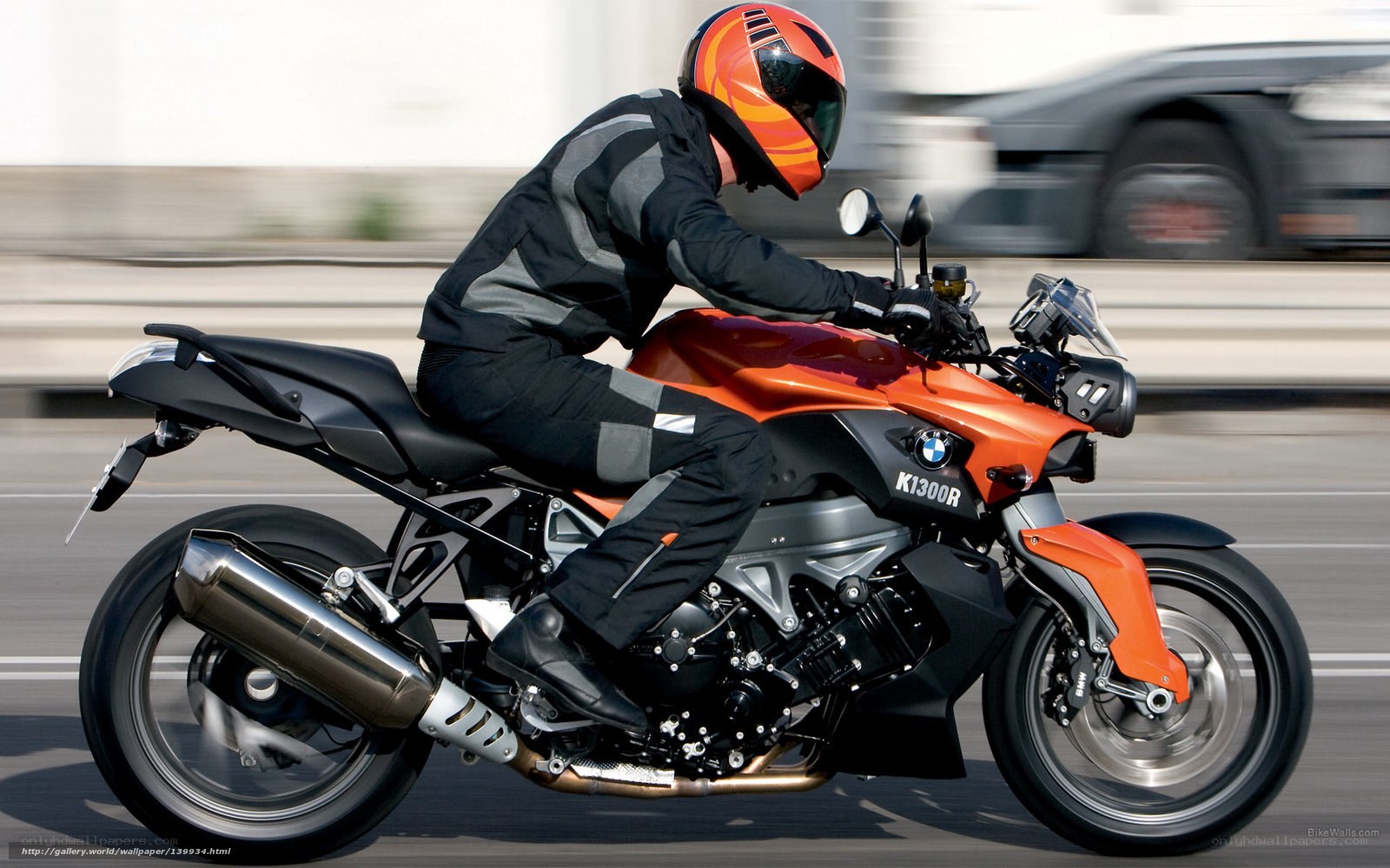 Rider on orange BMW motorcycle