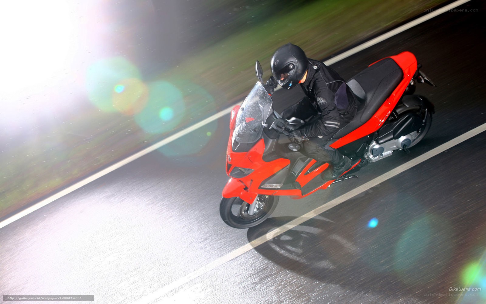 Rider on red motorcycle at night
