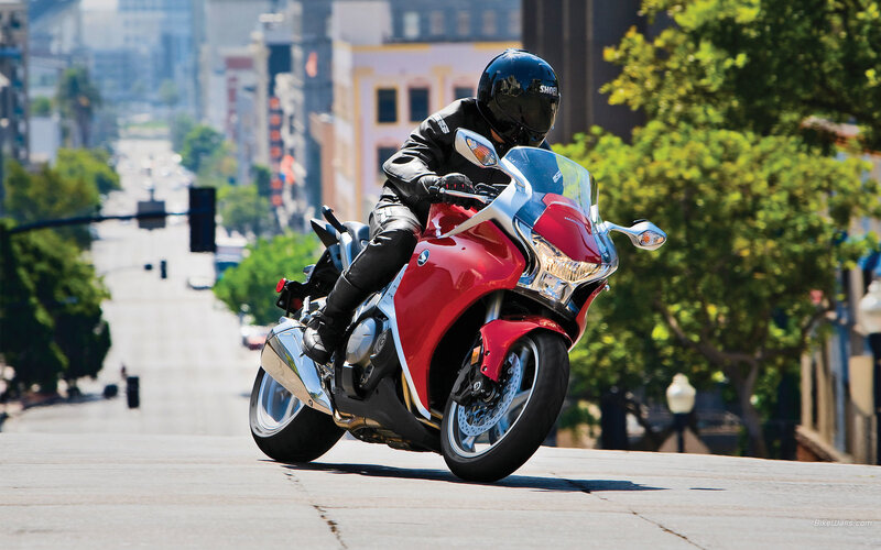 Rider on red motorcycle in city
