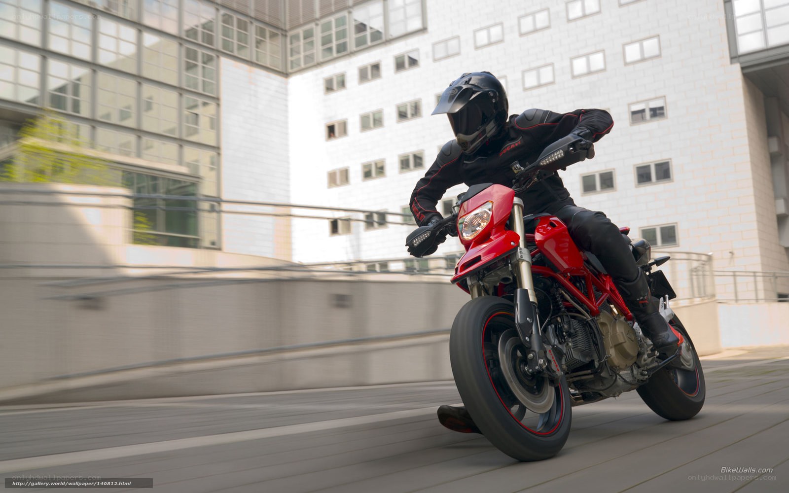 Rider on red motorcycle in city