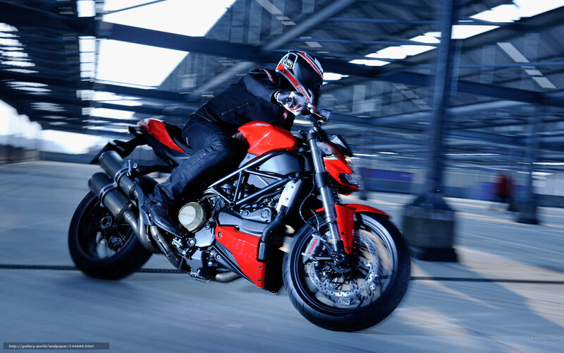 Rider on red motorcycle in motion