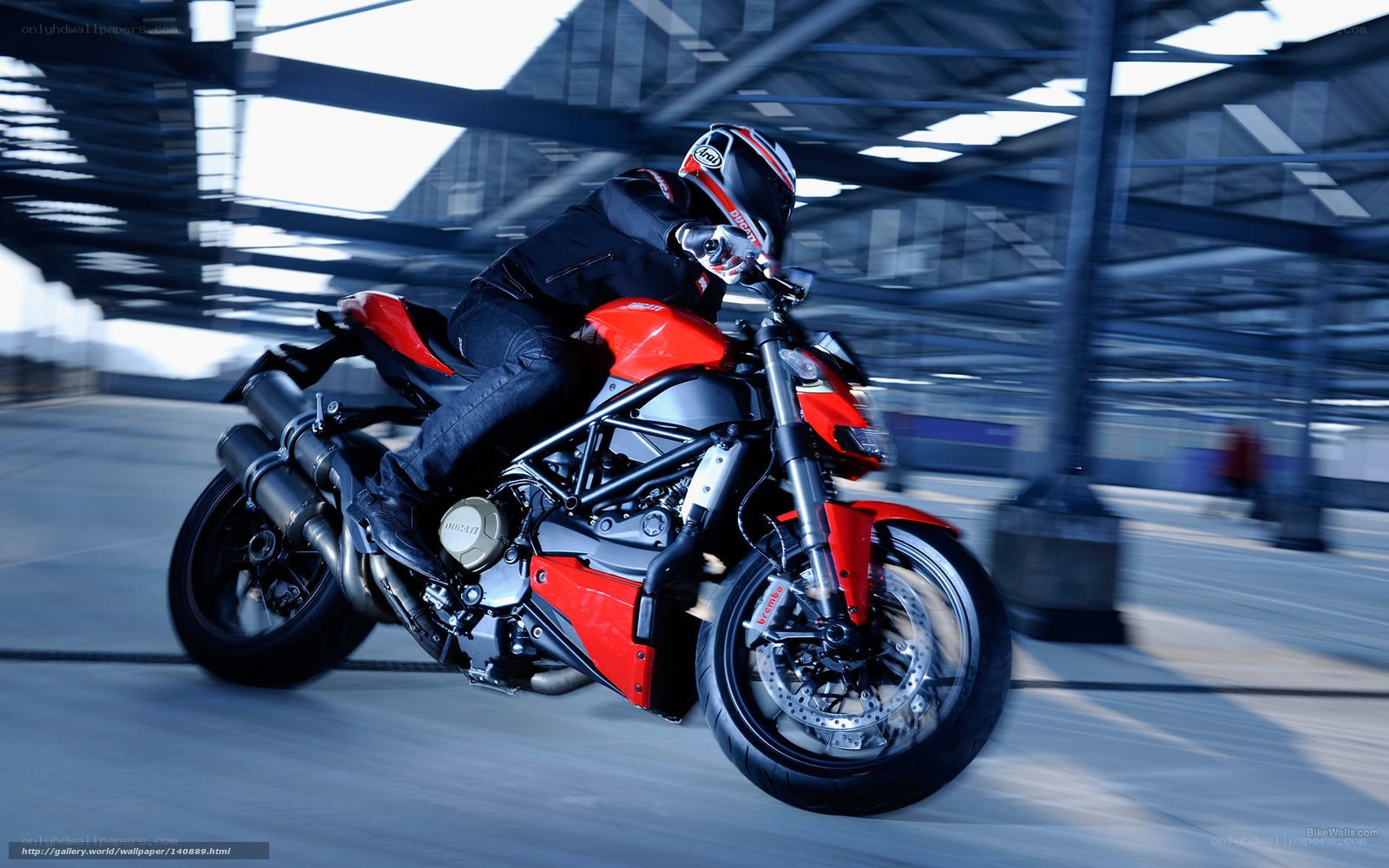 Rider on red motorcycle in motion
