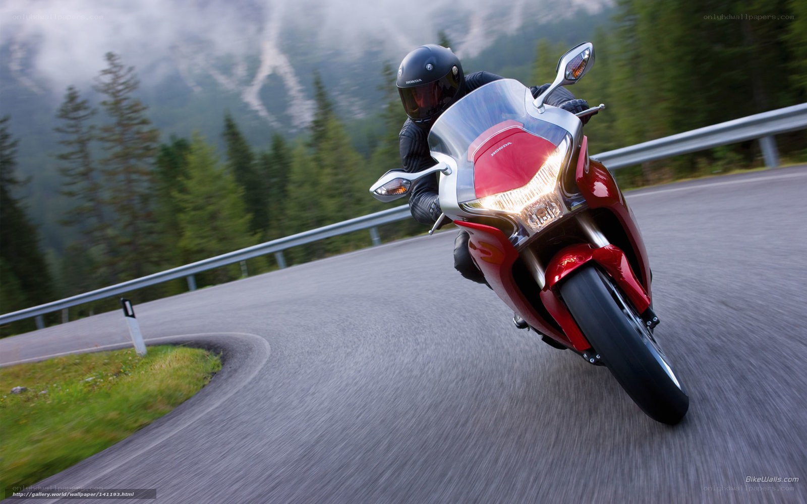 Rider on red motorcycle on mountain road