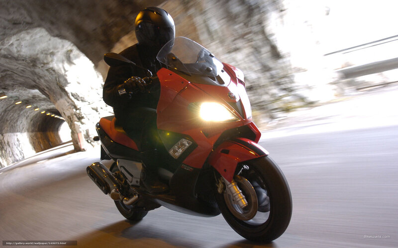 Rider on red scooter in tunnel