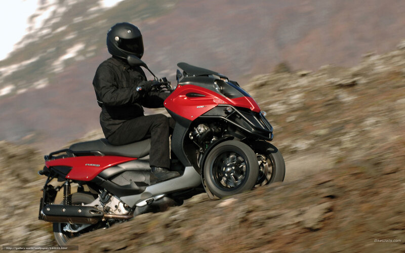 Rider on red three-wheeled scooter