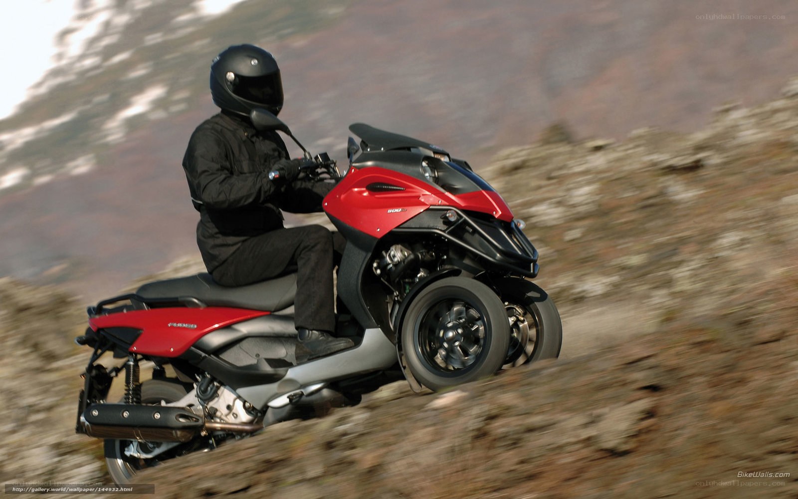 Rider on red three-wheeled scooter