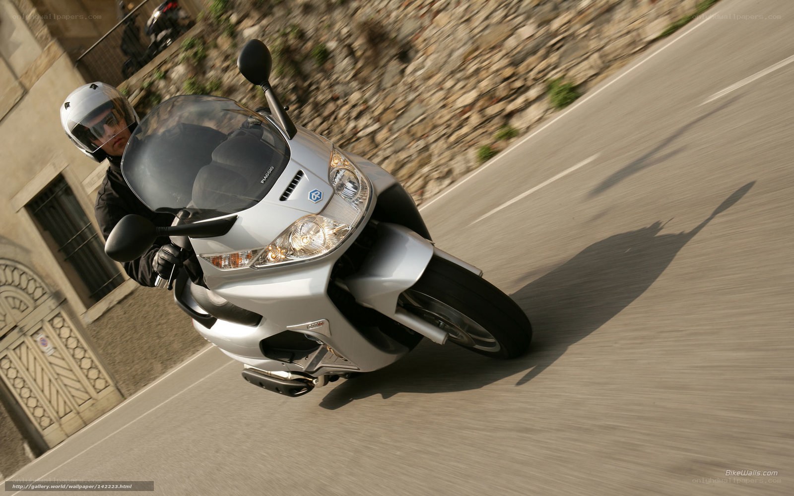 rider on silver scooter