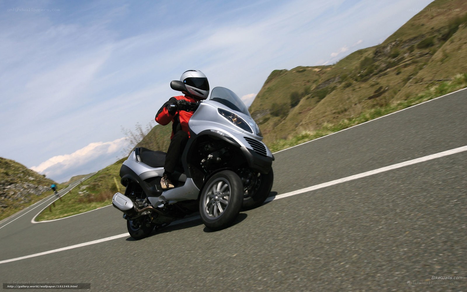 rider on three-wheeled scooter