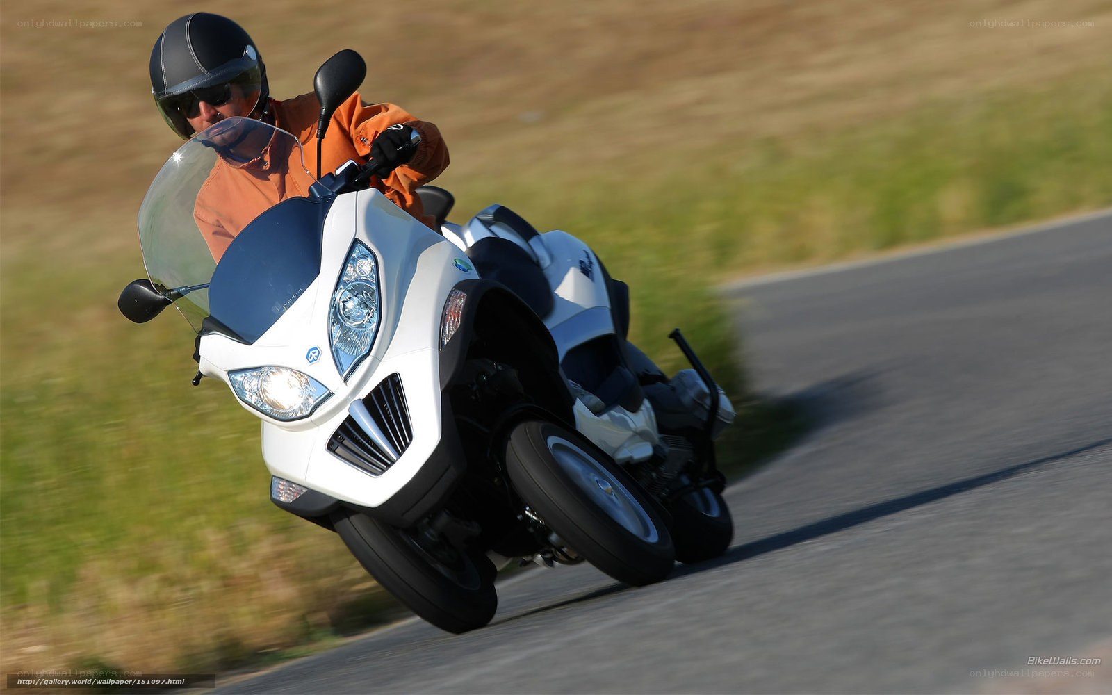rider on white three-wheeled motorcycle