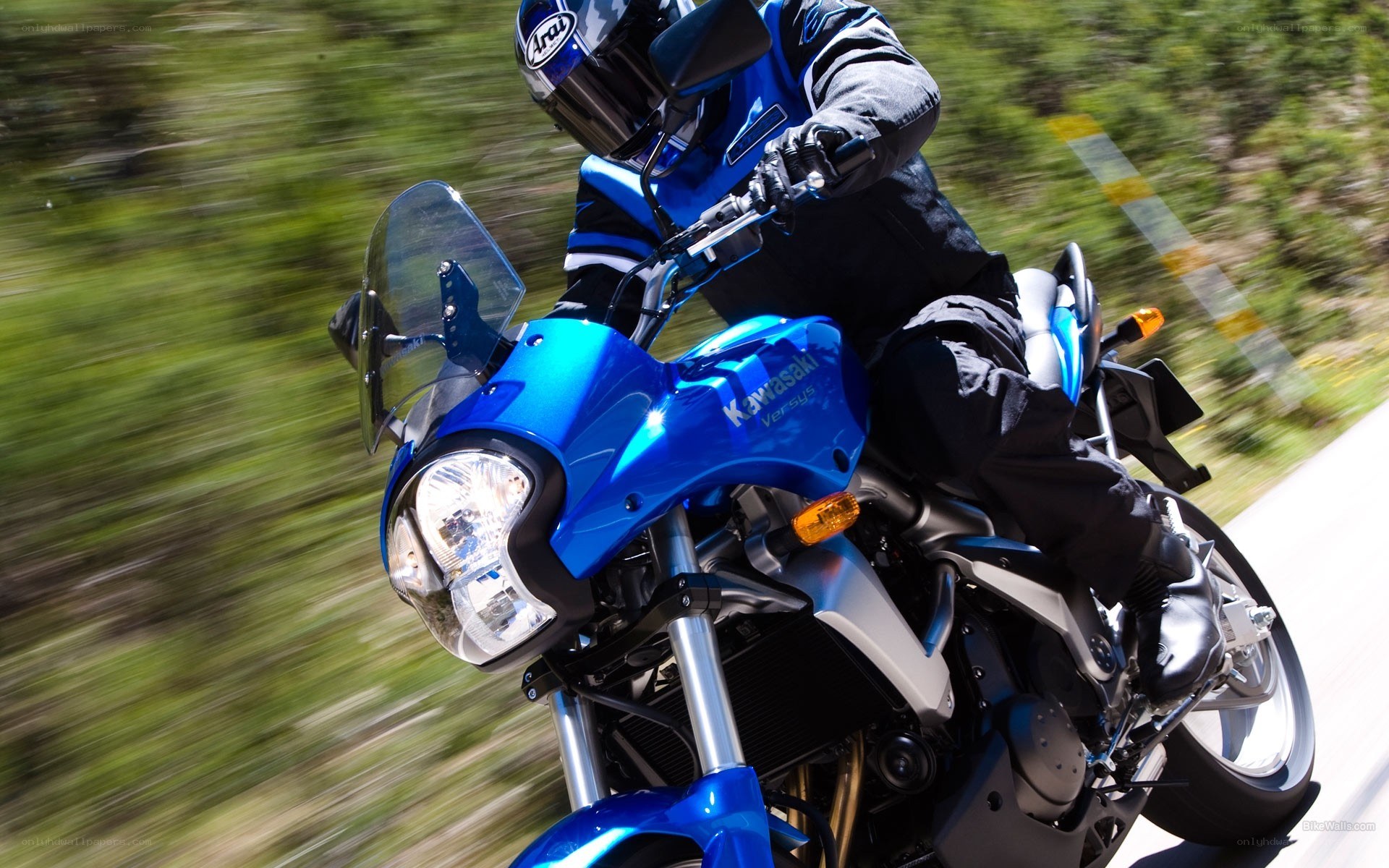 Riding a blue motorcycle