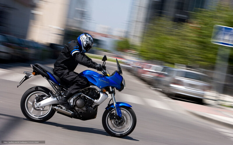 Riding a blue motorcycle