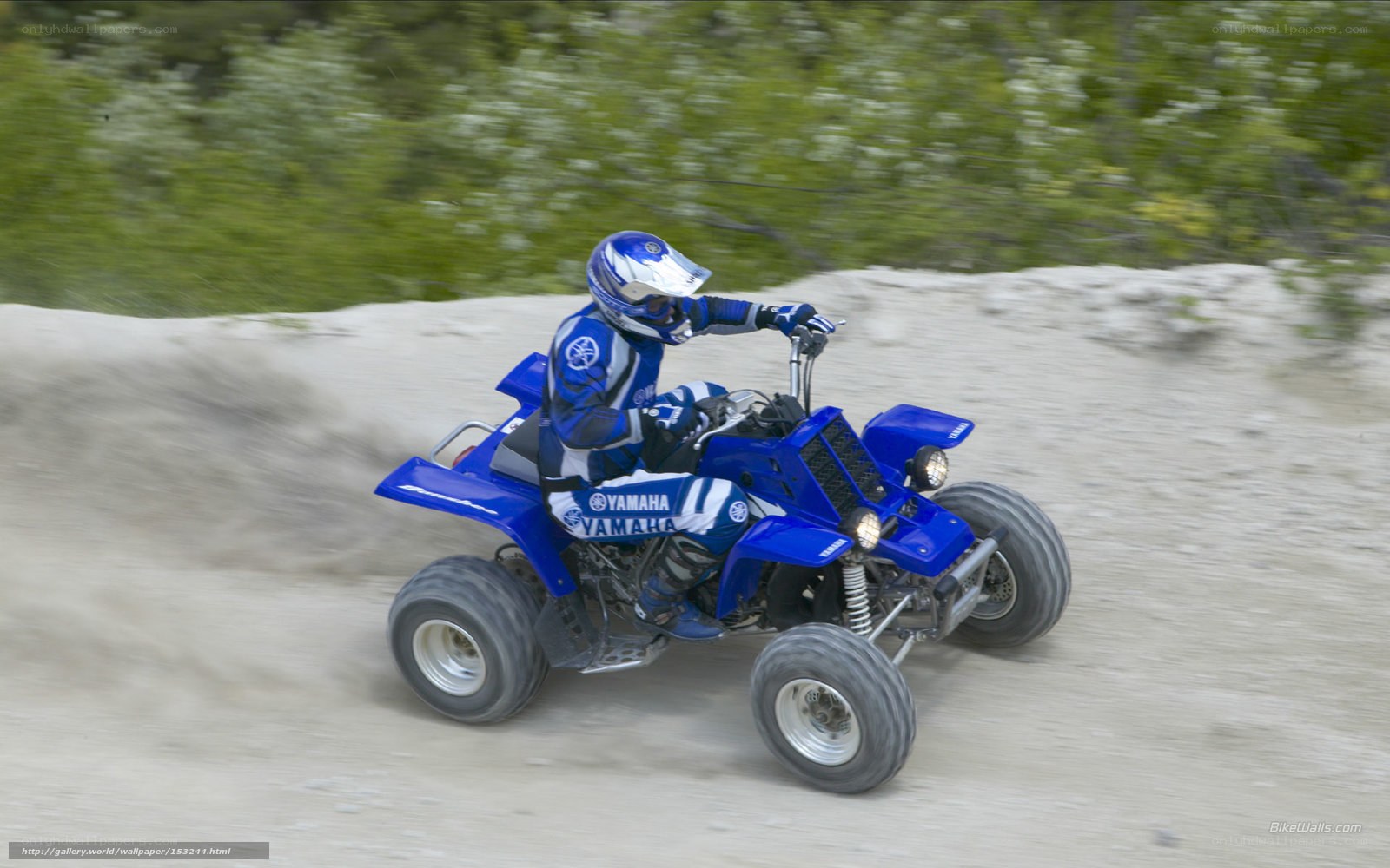 Riding a blue Yamaha ATV