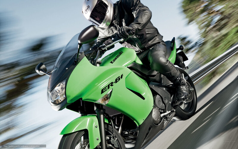 Riding a green Kawasaki motorcycle