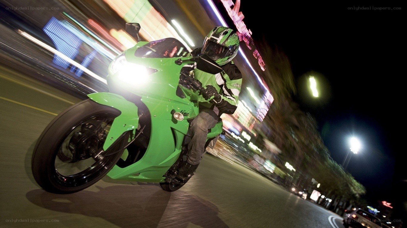Riding a green motorcycle at night