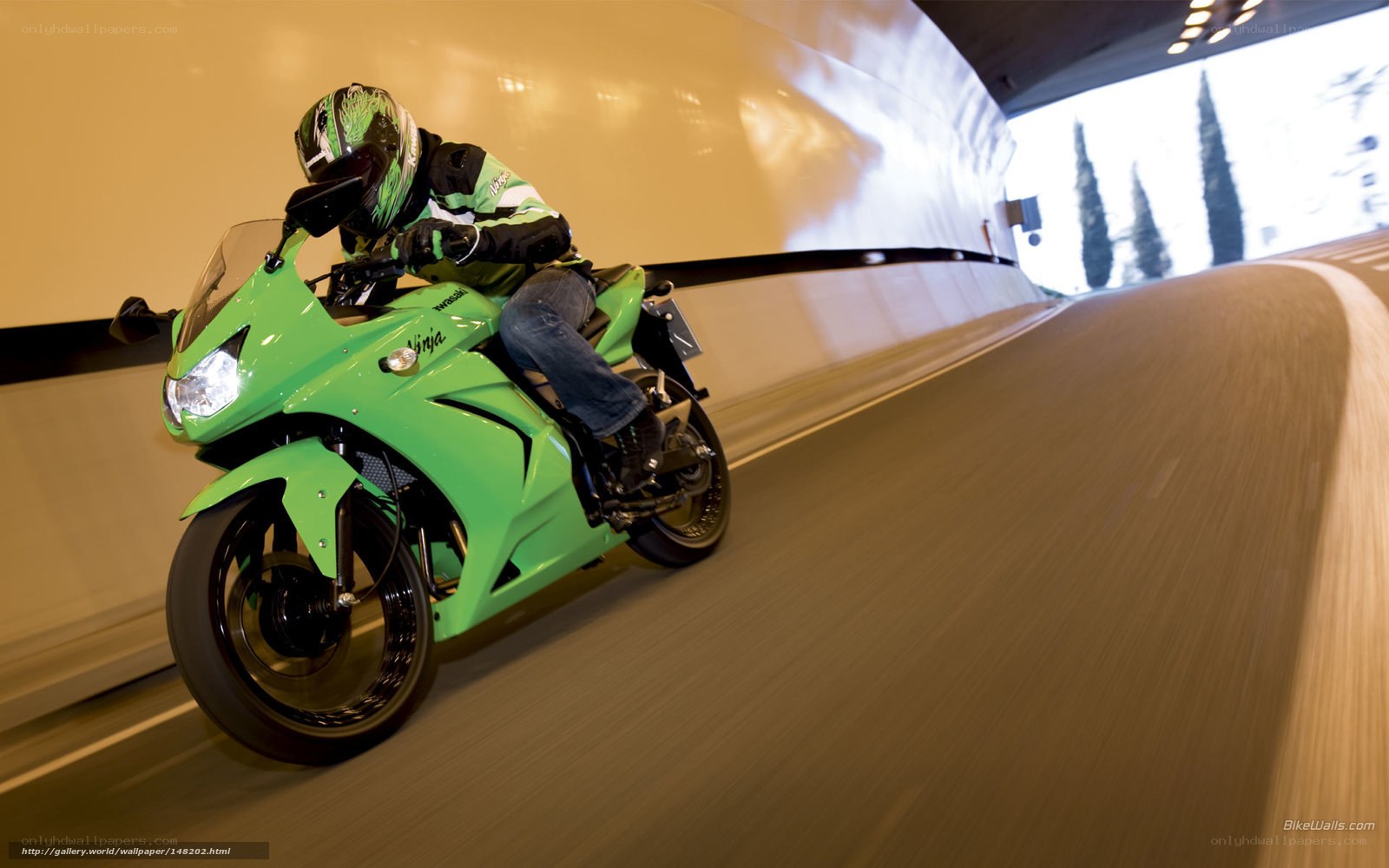 Riding a green motorcycle in a tunnel