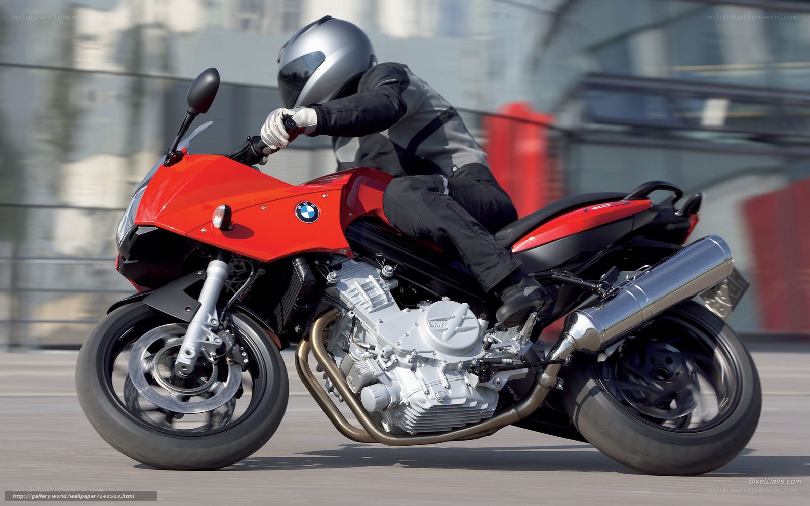 Riding a red BMW motorcycle