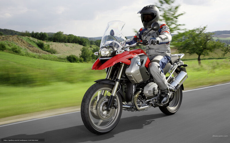 Riding a red BMW motorcycle