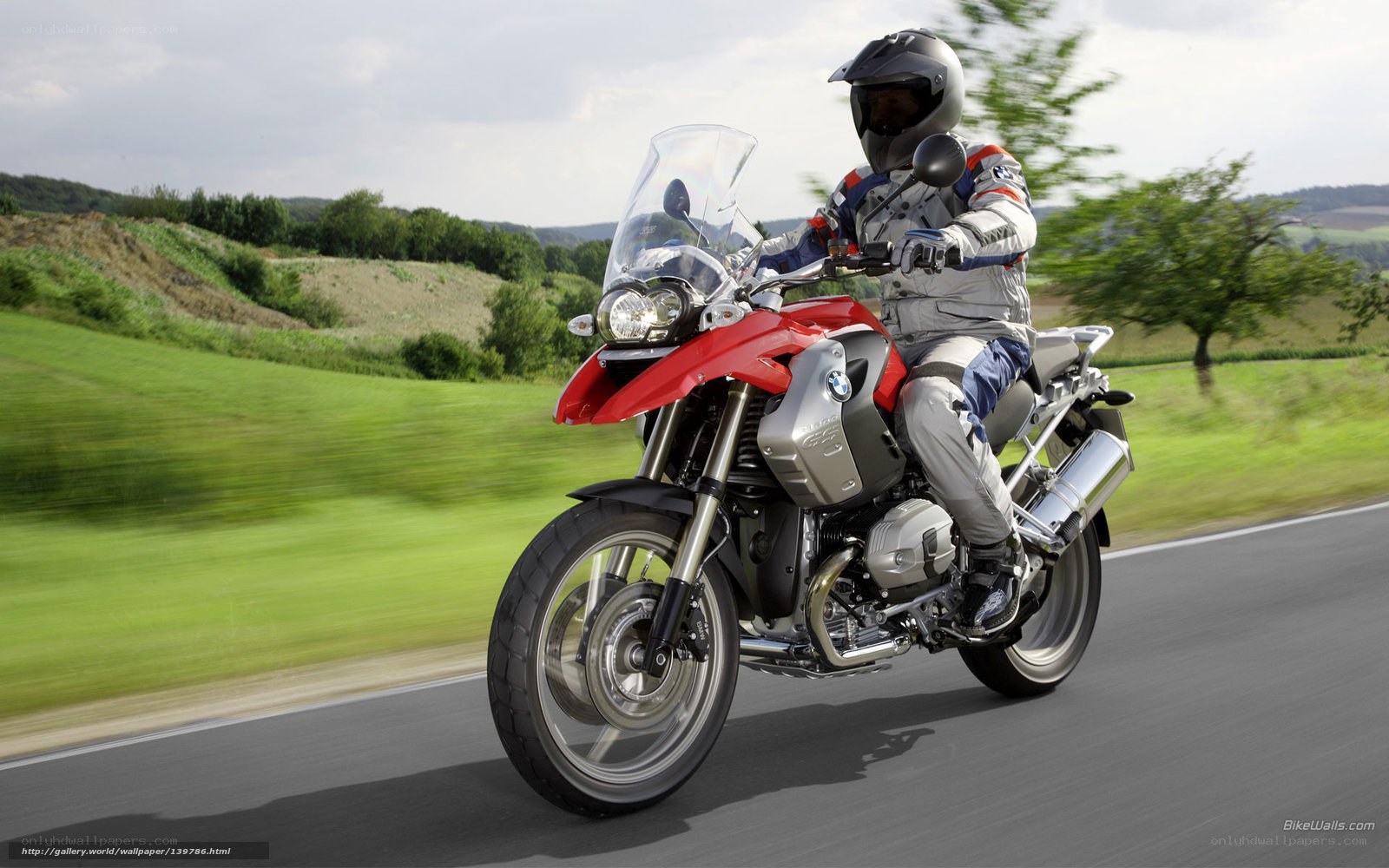 Riding a red BMW motorcycle