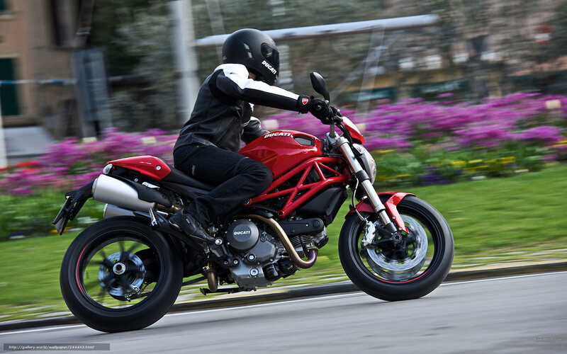Riding a red Ducati motorcycle