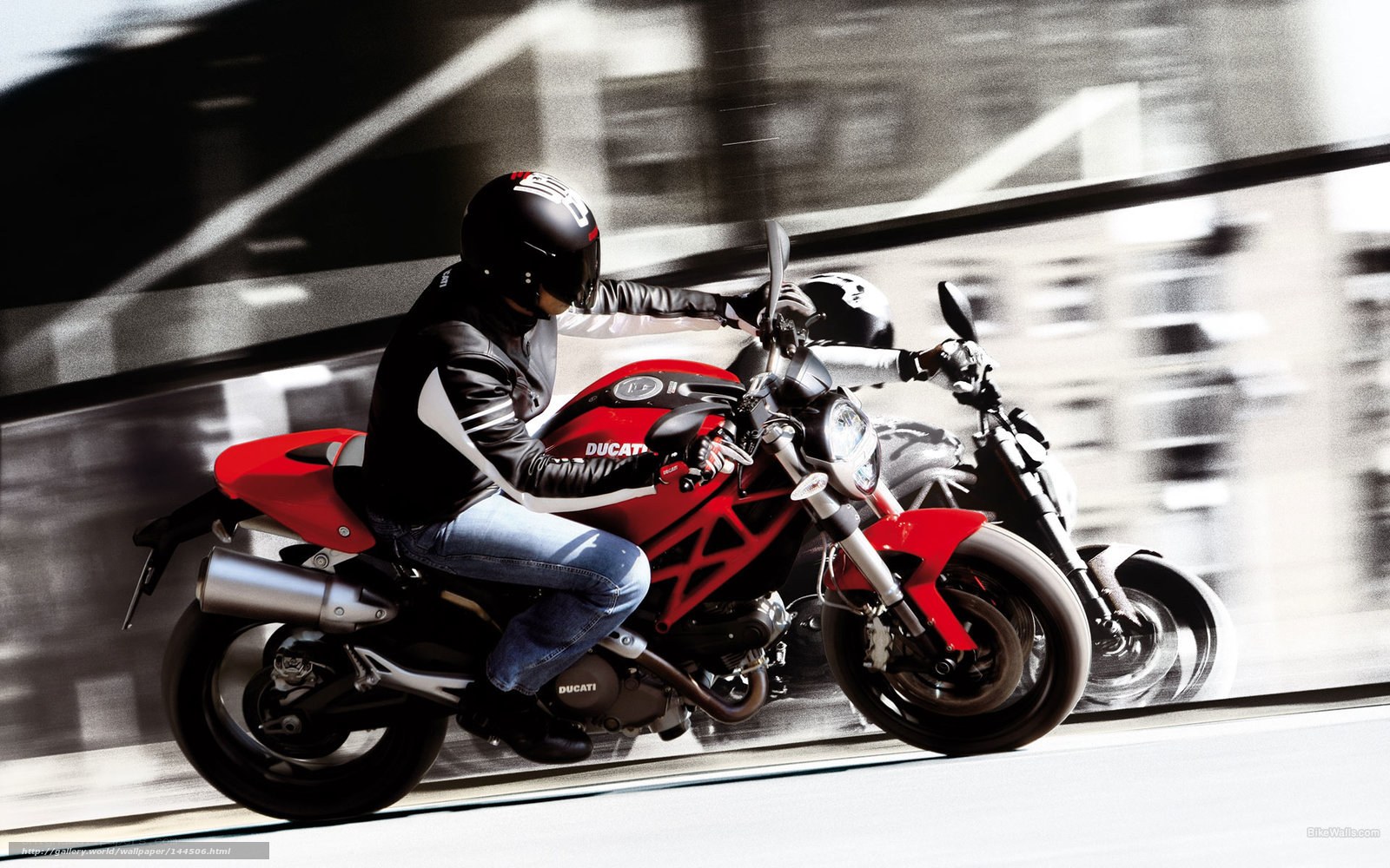Riding a red Ducati motorcycle