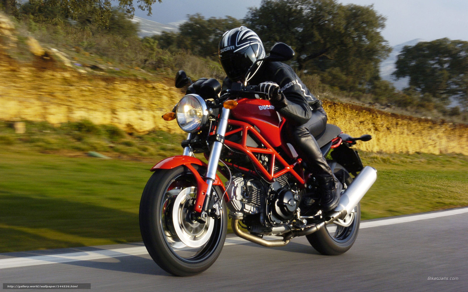 Riding a red Ducati motorcycle