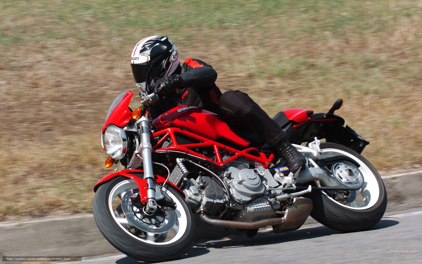 Riding a red Ducati motorcycle