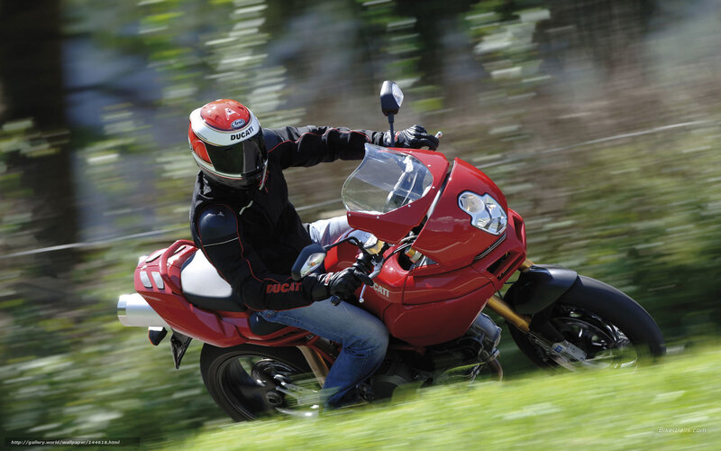 Riding a red Ducati motorcycle
