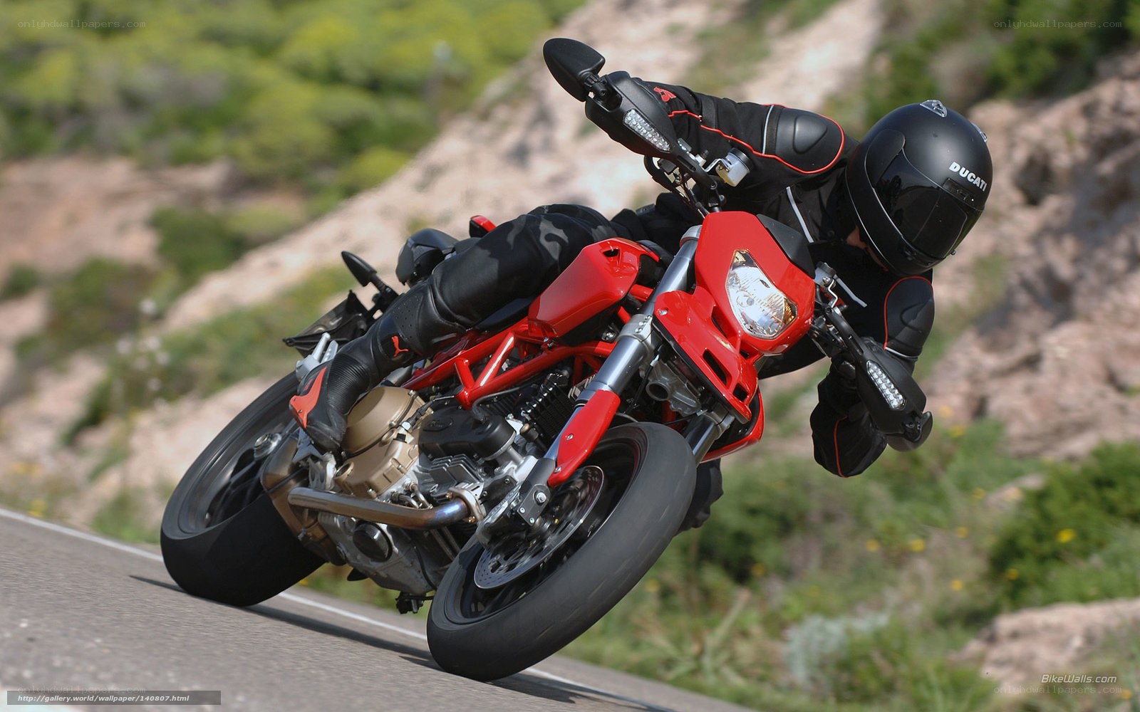 Riding a red Ducati motorcycle